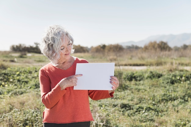 Woman with piece of paper outdoors