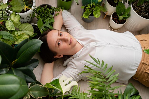 Free photo woman with plants frame