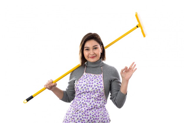 Woman with purple apron and a mop