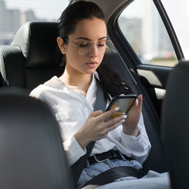 Woman with reading glasses using the phone