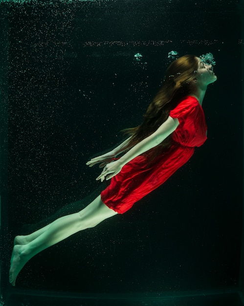 Free photo woman with red dress under water