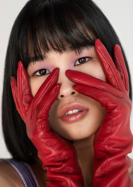 Free photo woman with red gloves posing