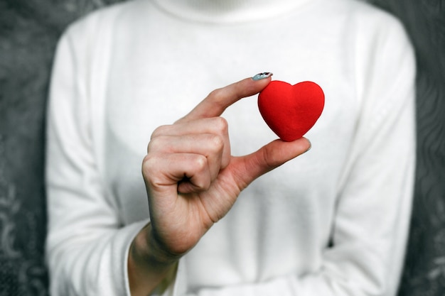 Free photo woman with a red heart in her hand