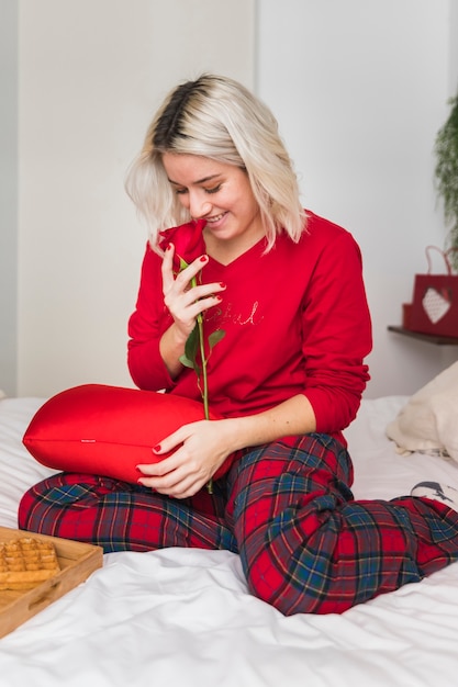 Free photo woman with a red rose on valentines day