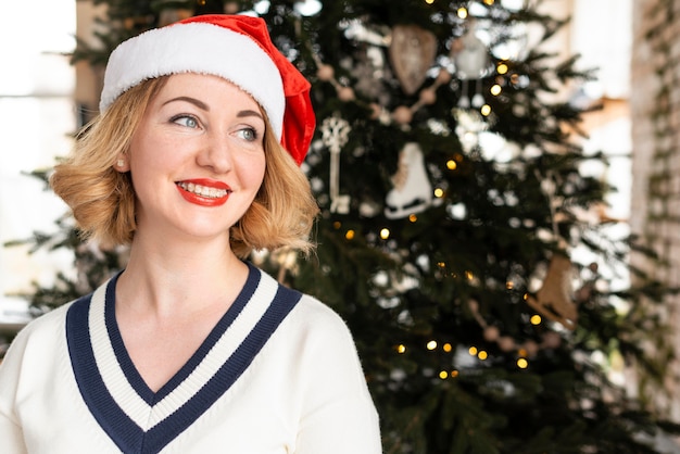 Woman with santa's hat looking away