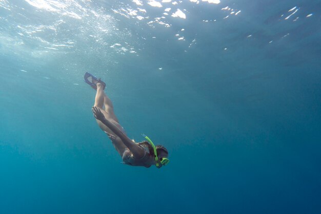 Woman with scuba gear swimming in the ocean