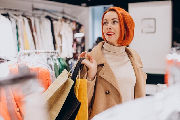 Woman with shopping bags making purchases in mall