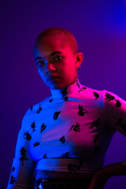 Free photo woman with short hair covered in neon light