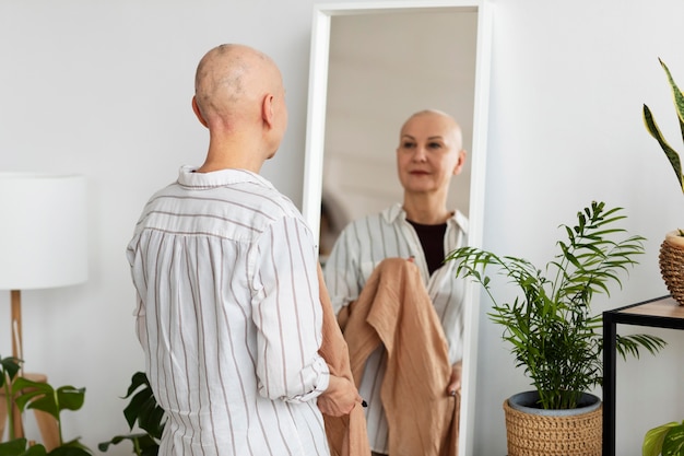 Woman with skin cancer looking in the mirror