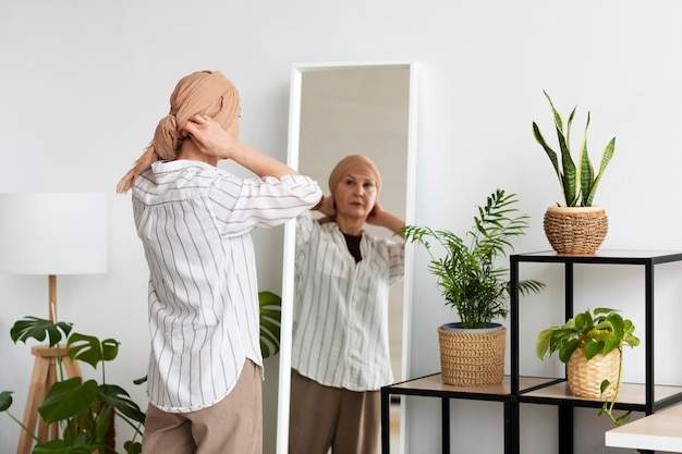 Woman with skin cancer looking in the mirror