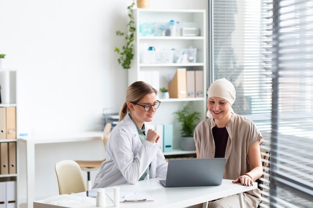 Woman with skin cancer talking with the doctor