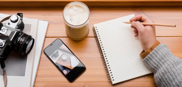 Woman with smartphone and cup of coffee