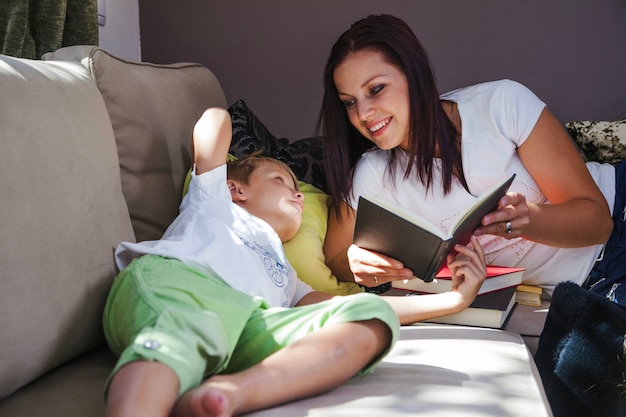 Free photo woman with son reading books