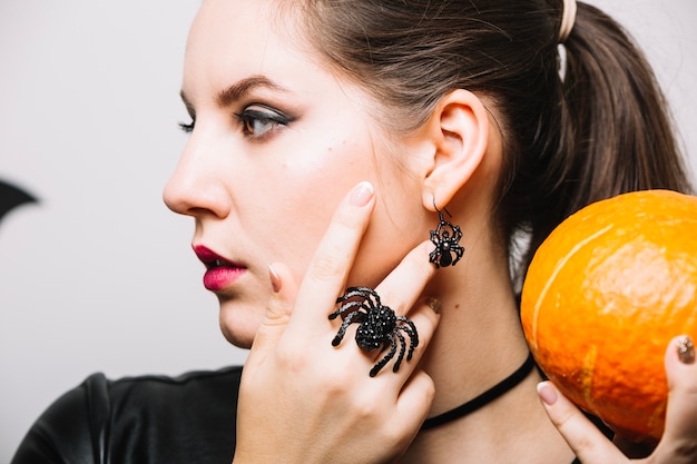 Free Photo woman with spider and pumpkin