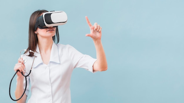 Woman with stethoscope using virtual reality headset