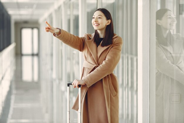 Woman with suitcase at the airport