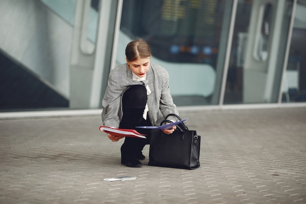 Free photo woman with suitcase standing by the airport