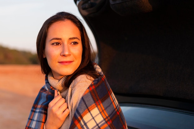 Woman with sun shining on her face while out in nature