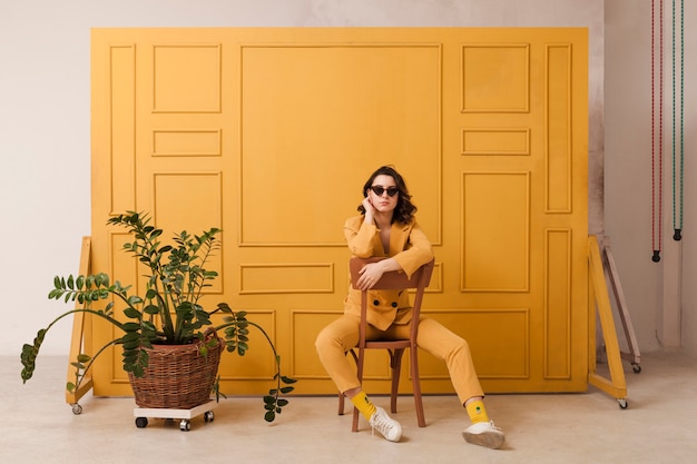 Free photo woman with sunglasses on chair