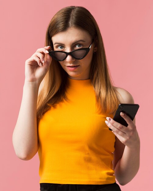 Woman with sunglasses and phone