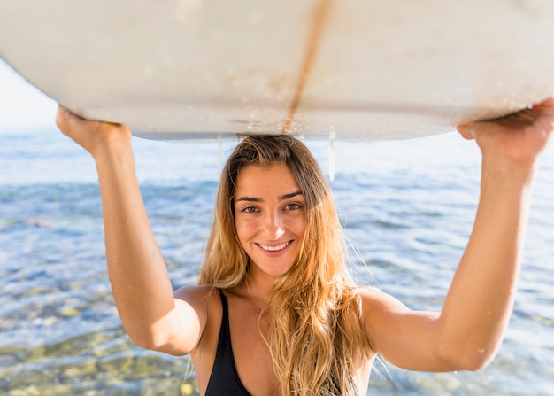 Woman with surfboard at the beach