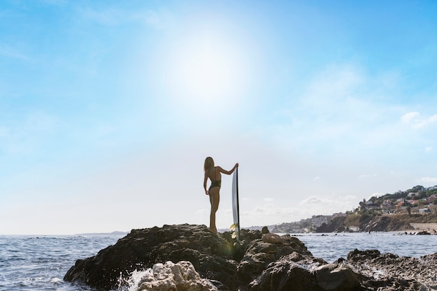 Free photo woman with surfboard at the beach