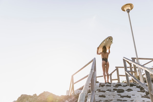 Free Photo woman with surfboard at the beach