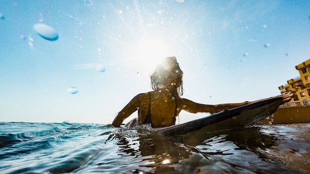 Free photo woman with surfboard in water