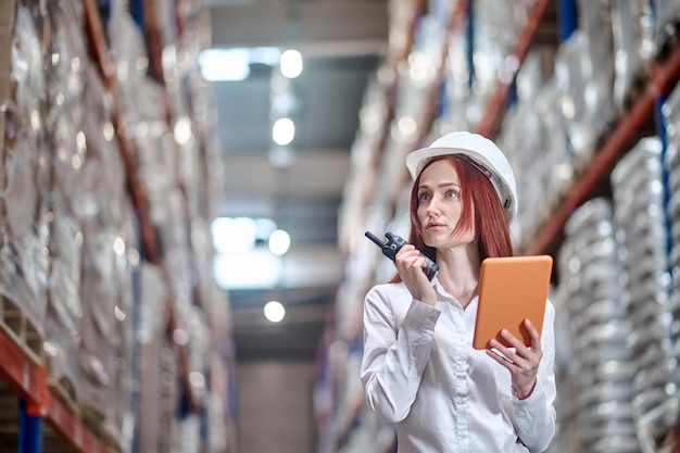 Free photo woman with tablet holding radio at chin level