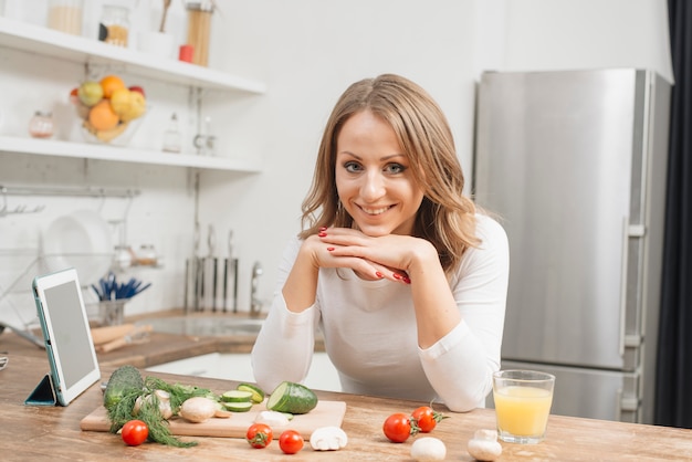 Woman with tablet in kitchen