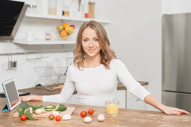 Woman with tablet in kitchen