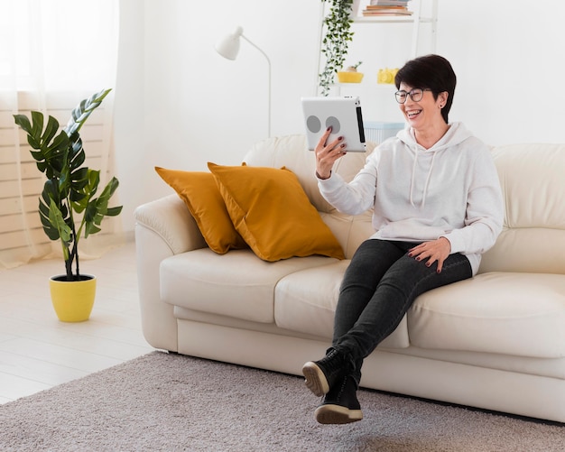 Woman with tablet on sofa