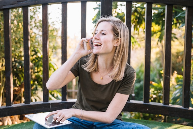 Free Photo woman with tablet speaking on phone