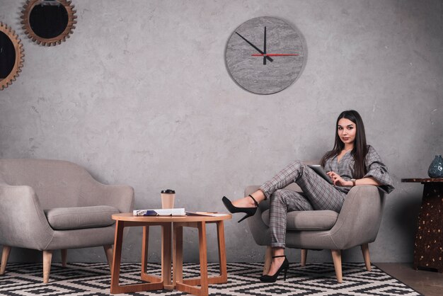 Woman with tablet in stylish room