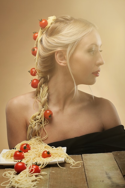 Free photo woman with tomatoes and spaghettis in her hair