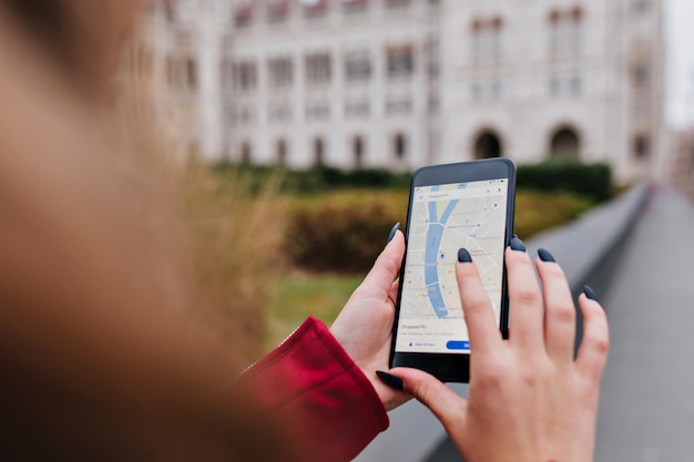 Free Photo woman with trendy manicure using gps for search right way