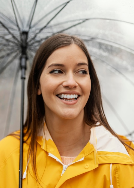 Free Photo woman with umbrella standing in the rain