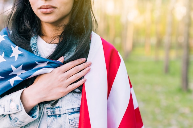 Woman with USA flag on shoulders