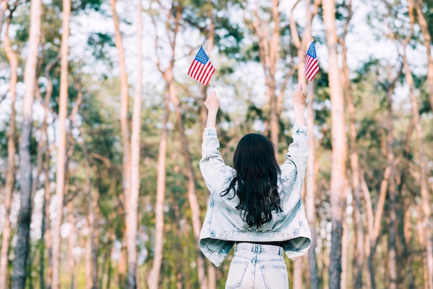 Free photo woman with usa flags in outstretched hands