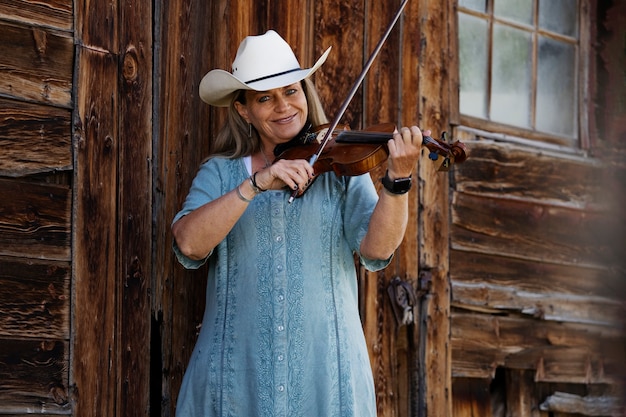 Free Photo woman with violine getting ready for country music concert