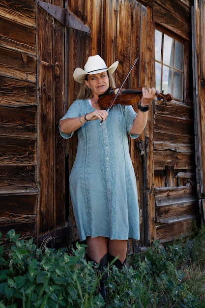 Free photo woman with violine getting ready for country music concert