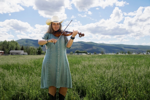 Free photo woman with violine getting ready for country music concert