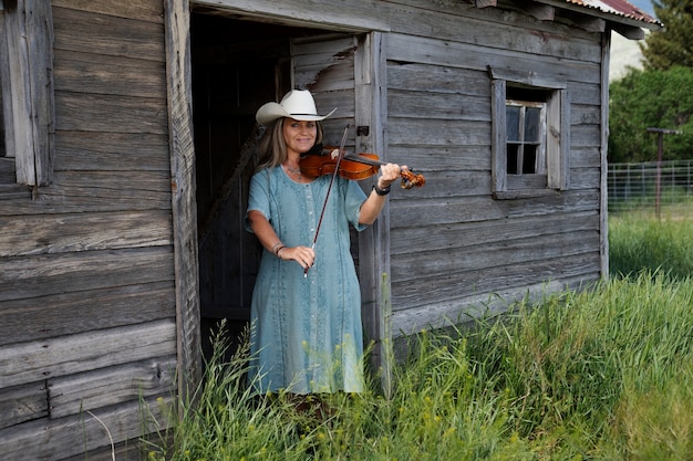 Free Photo woman with violine getting ready for country music concert