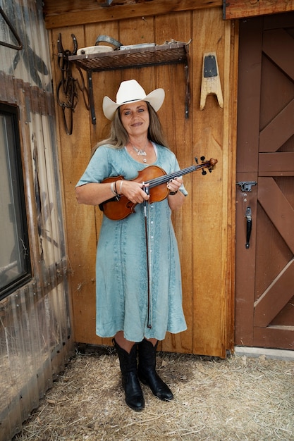 Free Photo woman with violine getting ready for country music concert