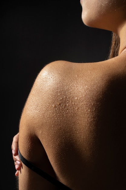 Woman with water drops on skin back view