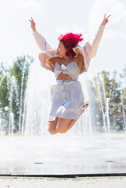 Woman with water fountain in background