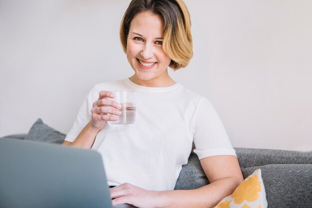 Woman with water and laptop