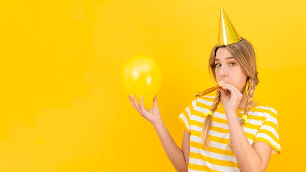 Woman with whistler blower and balloon