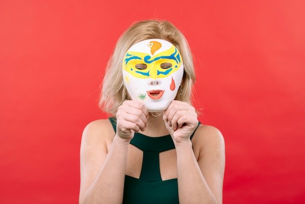 Free Photo woman with white carnival mask in hands