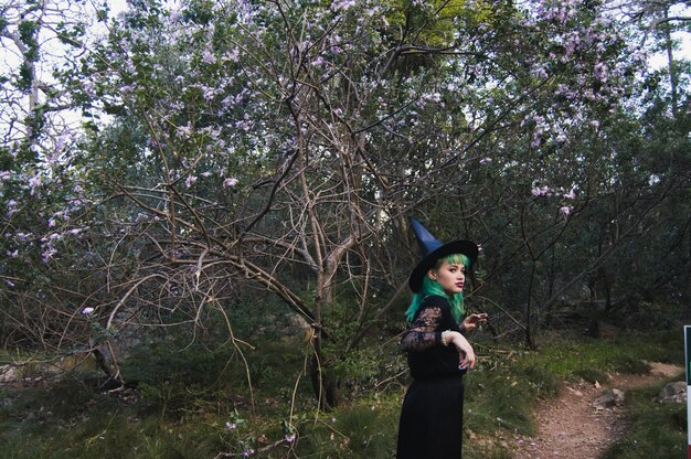 Woman in woods in Halloween costume